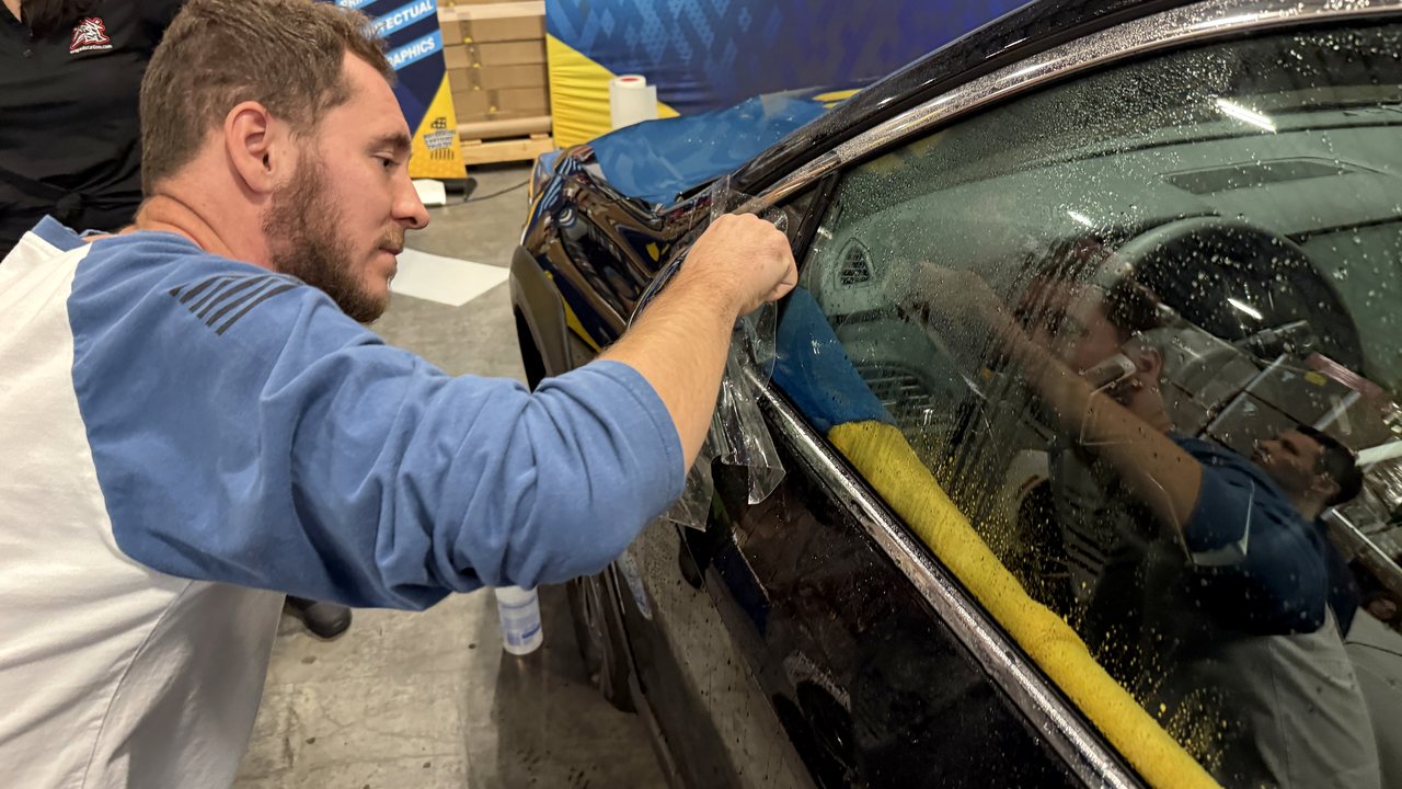 Next Wave technician performing careful vehicle process work inside the Pasadena shop