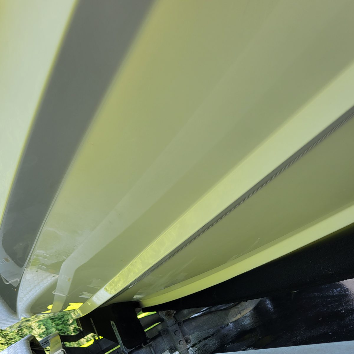 The same boat hull clean and bright after marine detailing