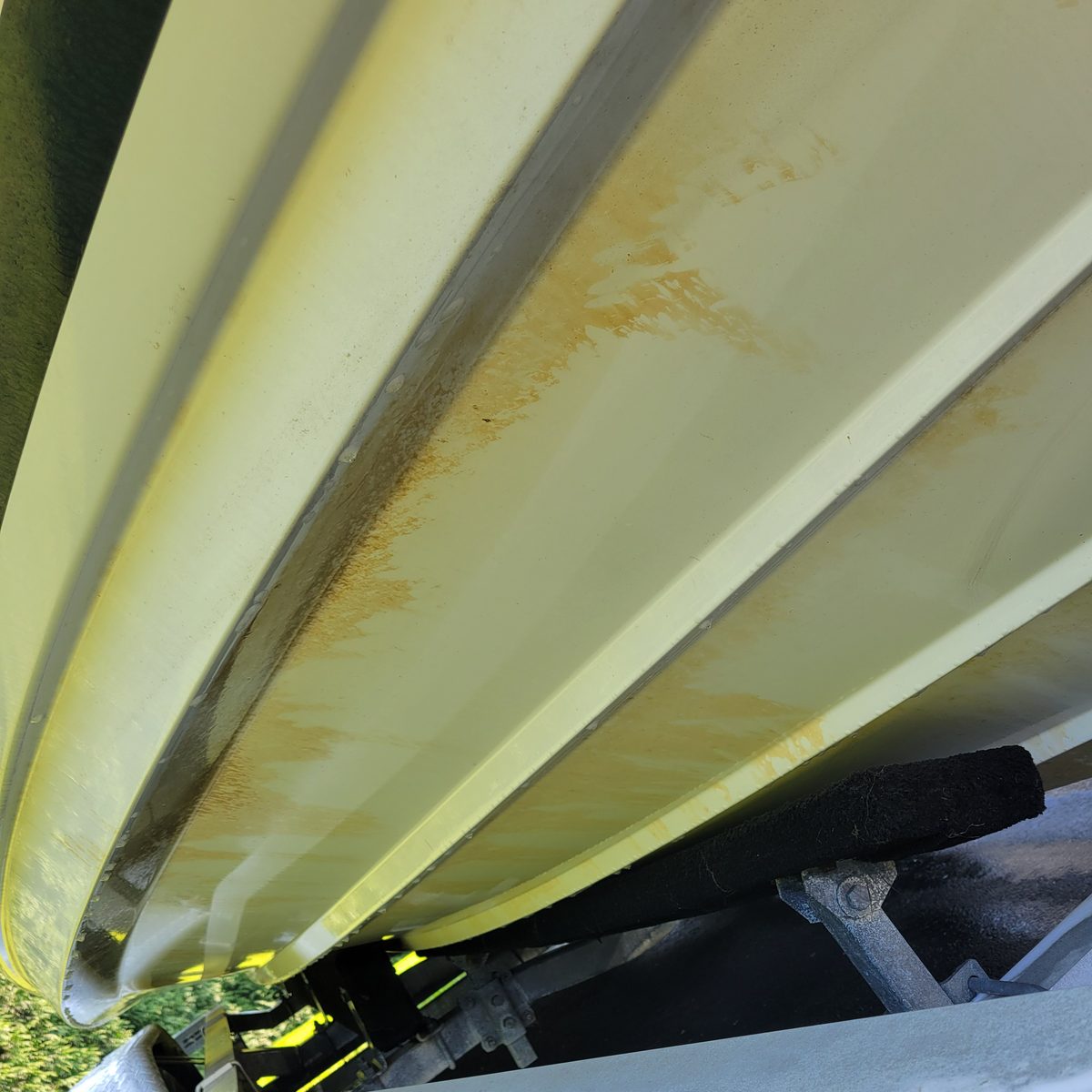Brown scum and waterline staining on a boat hull before marine detailing