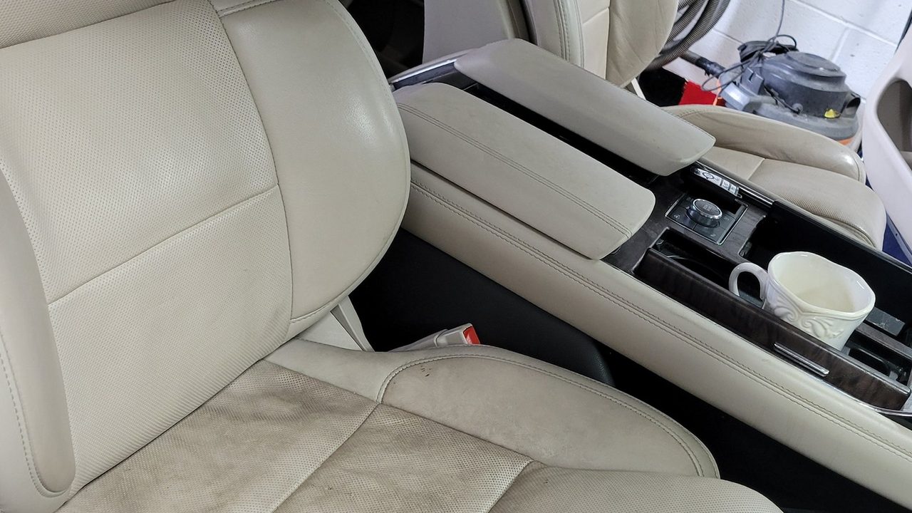 Freshly detailed cream leather seats and center console in a luxury SUV